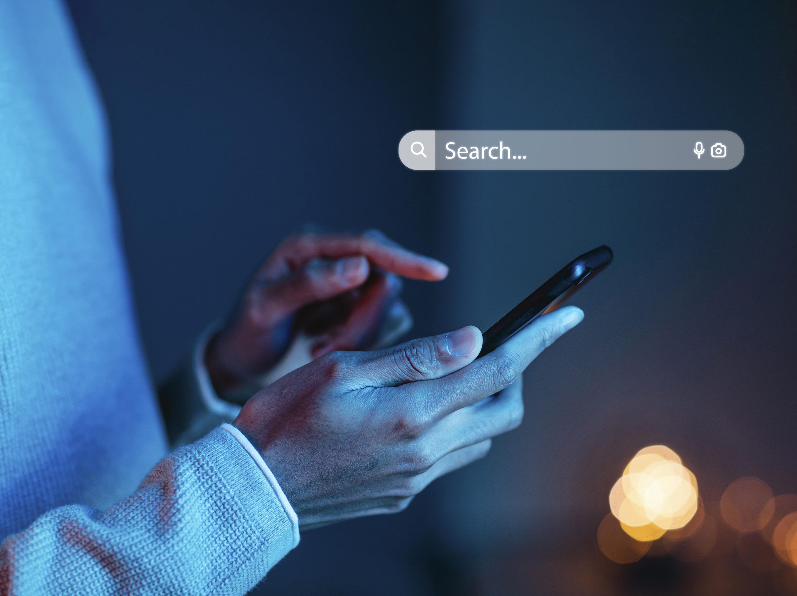 A person searching on a mobile phone with a digital search bar, representing mobile strategies for Johns Creek SEO Growth.
